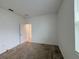 Bedroom with neutral carpet and white walls with a view into the hallway at 6300 Chirpine Ln, St Cloud, FL 34771