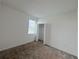 A bedroom with carpeted floors, a window, and a closet at 6300 Chirpine Ln, St Cloud, FL 34771