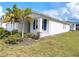 Side view of a charming single-Gathering home with blue shutters and tropical landscaping at 6300 Chirpine Ln, St Cloud, FL 34771