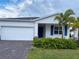 Charming single-Gathering home with a two-car garage, brick paver driveway and tropical landscaping at 6300 Chirpine Ln, St Cloud, FL 34771