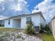 Back view of a single-Gathering home with solar panels and an open patio at 6300 Chirpine Ln, St Cloud, FL 34771