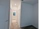Hallway view features a bathroom, multiple closets, and carpet flooring at 6300 Chirpine Ln, St Cloud, FL 34771
