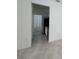 Hallway view leading to kitchen with stainless steel appliances and ample cabinet space at 6300 Chirpine Ln, St Cloud, FL 34771
