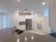 An open kitchen features stainless steel appliances, ample counter space, and tile flooring at 6300 Chirpine Ln, St Cloud, FL 34771