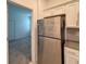 Shows the kitchen with stainless steel refrigerator and white cabinets at 6300 Chirpine Ln, St Cloud, FL 34771