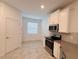 A bright and spacious kitchen features modern appliances and a window, creating a welcoming atmosphere at 6300 Chirpine Ln, St Cloud, FL 34771