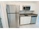 Kitchen area featuring stainless appliances, white cabinets and gray countertop at 6300 Chirpine Ln, St Cloud, FL 34771