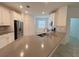 Modern kitchen featuring stainless steel appliances, a large island, and ample counter space at 6300 Chirpine Ln, St Cloud, FL 34771