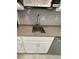 Stainless kitchen sink with gray countertops, white cabinets, and tile backsplash at 6300 Chirpine Ln, St Cloud, FL 34771