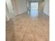 Living room with ceramic tile flooring and view to sliding glass doors at 6300 Chirpine Ln, St Cloud, FL 34771
