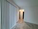 A living room area with tile floors and vertical blinds on sliding glass doors at 6300 Chirpine Ln, St Cloud, FL 34771