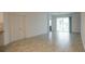 Living room with ceramic tile flooring and view to sliding glass doors at 6300 Chirpine Ln, St Cloud, FL 34771