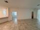 The spacious living room has tile floors and multiple windows, offering plentiful natural light at 6300 Chirpine Ln, St Cloud, FL 34771