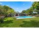Private backyard featuring a large pool, lush lawn, beautiful landscaping, and ample space for activities at 811 Oregon St, Orlando, FL 32803