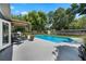 Spacious backyard featuring a large swimming pool, pergola, lush lawn, and mature trees at 811 Oregon St, Orlando, FL 32803