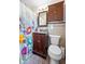 Traditional bathroom featuring classic floral shower curtain, wooden vanity, and vintage tile floors at 811 Oregon St, Orlando, FL 32803