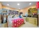 Cozy bedroom with colorful decor, wood floors, built-in shelving, and many decorations at 811 Oregon St, Orlando, FL 32803