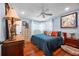 Charming bedroom with blue walls, hardwood floors, ceiling fan, and colorful decorative pillows at 811 Oregon St, Orlando, FL 32803