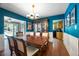 Stylish dining room with blue walls, wooden table, and a view into the kitchen, perfect for entertaining at 811 Oregon St, Orlando, FL 32803