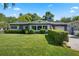 Charming single-story home featuring a well-manicured lawn and lush, trimmed hedges, creating a welcoming curb appeal at 811 Oregon St, Orlando, FL 32803