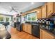 Traditional kitchen with wood floors, cabinets, black countertops, and black and white checkered backsplash at 811 Oregon St, Orlando, FL 32803