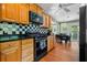 Traditional kitchen with wood cabinets, black countertops, and black and white checkered backsplash at 811 Oregon St, Orlando, FL 32803
