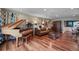 Spacious living room with gleaming hardwood floors, a grand piano, and a comfortable leather sofa at 811 Oregon St, Orlando, FL 32803