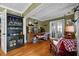 Inviting living room featuring hardwood floors, a built-in cabinet, and an exposed brick wall at 811 Oregon St, Orlando, FL 32803