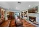 Cozy living room featuring hardwood floors, a fireplace, and a view into the adjacent dining room at 811 Oregon St, Orlando, FL 32803