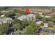 Aerial view of the apartment complex, showcasing ample parking and proximity to a beautiful lake at 8816 Dunes Ct # 303, Kissimmee, FL 34747