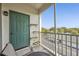 Balcony area with a door and view of trees and a parking area at 8816 Dunes Ct # 303, Kissimmee, FL 34747