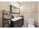 Bathroom showcases a vanity, framed mirror, and tile accents at 8816 Dunes Ct # 303, Kissimmee, FL 34747