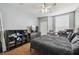 Bedroom featuring a window with blinds, closet, ceiling fan, and wood-look floors at 8816 Dunes Ct # 303, Kissimmee, FL 34747