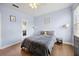 Cozy bedroom featuring wood floors, cool paint, and comfortable furniture at 8816 Dunes Ct # 303, Kissimmee, FL 34747