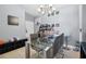 Cozy dining room with a glass-top table, seating for four, and a modern light fixture creating a stylish space at 8816 Dunes Ct # 303, Kissimmee, FL 34747