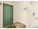 Inviting entryway featuring a green door, modern door number, and convenient trash receptacle for residents at 8816 Dunes Ct # 303, Kissimmee, FL 34747