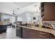 Open-concept kitchen with a breakfast bar and modern appliances, seamlessly connecting to the dining and living area at 8816 Dunes Ct # 303, Kissimmee, FL 34747