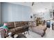 Bright living room featuring tile flooring, a ceiling fan, and a large sectional sofa at 8816 Dunes Ct # 303, Kissimmee, FL 34747