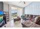 Comfortable living room showcasing tile flooring, a sectional sofa, and a balcony view at 8816 Dunes Ct # 303, Kissimmee, FL 34747