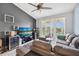 Relaxing living room with a ceiling fan, balcony access, and media center at 8816 Dunes Ct # 303, Kissimmee, FL 34747