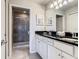 Bathroom featuring a shower, and a double sink with modern fixtures and white vanity at 8911 Geneve Ct, Kissimmee, FL 34747