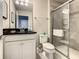 Bathroom boasts a tiled shower with glass doors, a toilet, and a vanity with modern fixtures at 8911 Geneve Ct, Kissimmee, FL 34747
