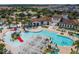 Aerial view of the large community pool with water slide, lounge chairs, and other resort-style amenities at 8911 Geneve Ct, Kissimmee, FL 34747