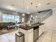 Stylish open kitchen featuring granite countertops, stainless steel appliances, and a large island at 8911 Geneve Ct, Kissimmee, FL 34747