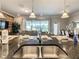 Open-concept kitchen flowing into the living space, featuring an island with a sink and granite countertops at 8911 Geneve Ct, Kissimmee, FL 34747