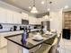 Bright, open kitchen with white cabinetry, a breakfast bar, and stainless steel appliances at 8911 Geneve Ct, Kissimmee, FL 34747