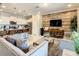 Open-concept living area shows a decorative wood panel, TV, and kitchen with seating island at 8911 Geneve Ct, Kissimmee, FL 34747