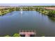 An aerial view of the pond with a fountain and a pier at 8911 Geneve Ct, Kissimmee, FL 34747