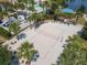 An aerial view of the community sand volleyball court surrounded by palm trees at 8911 Geneve Ct, Kissimmee, FL 34747