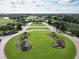 Aerial view of a neighborhood entrance with beautifully landscaped median and clubhouse at 9979 Winnington St, Orlando, FL 32832